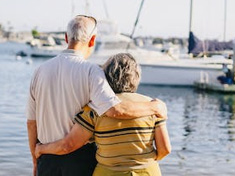 elderly couple looking at yachts